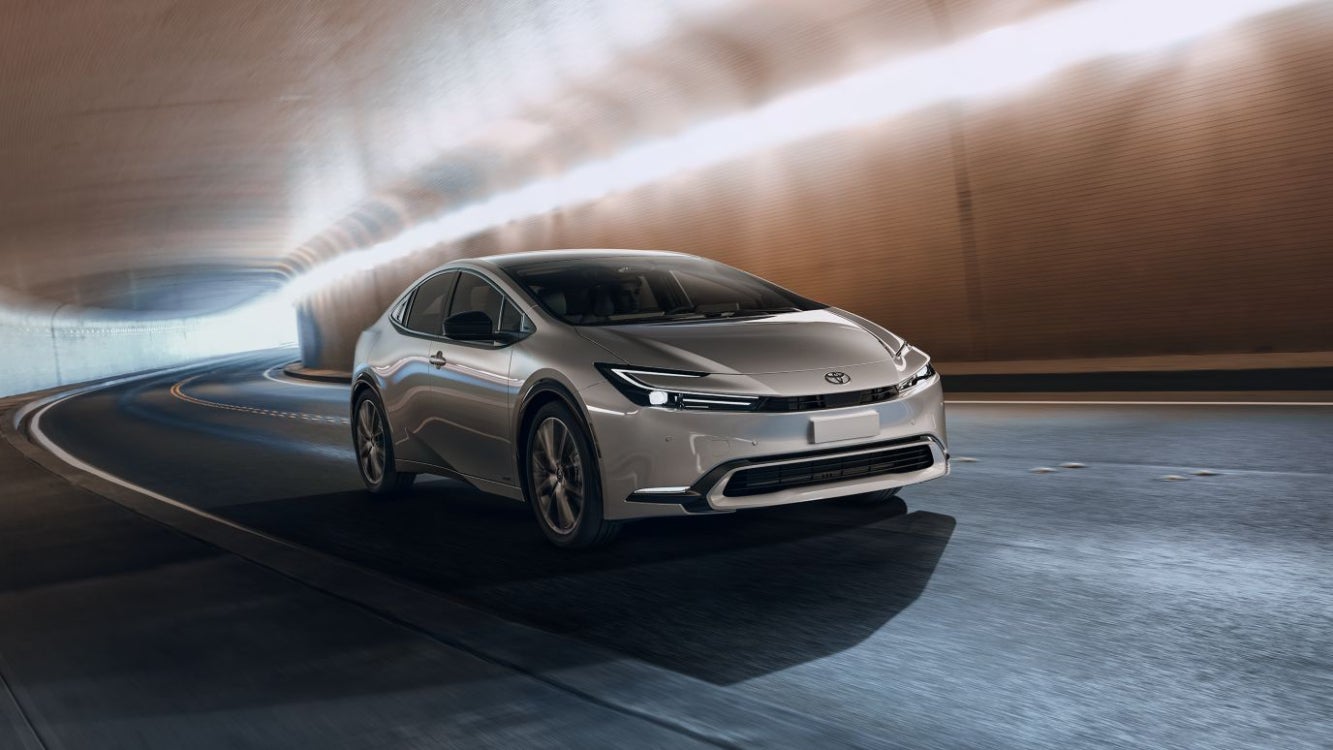 A silver Toyota Prius driving through a tunnel.